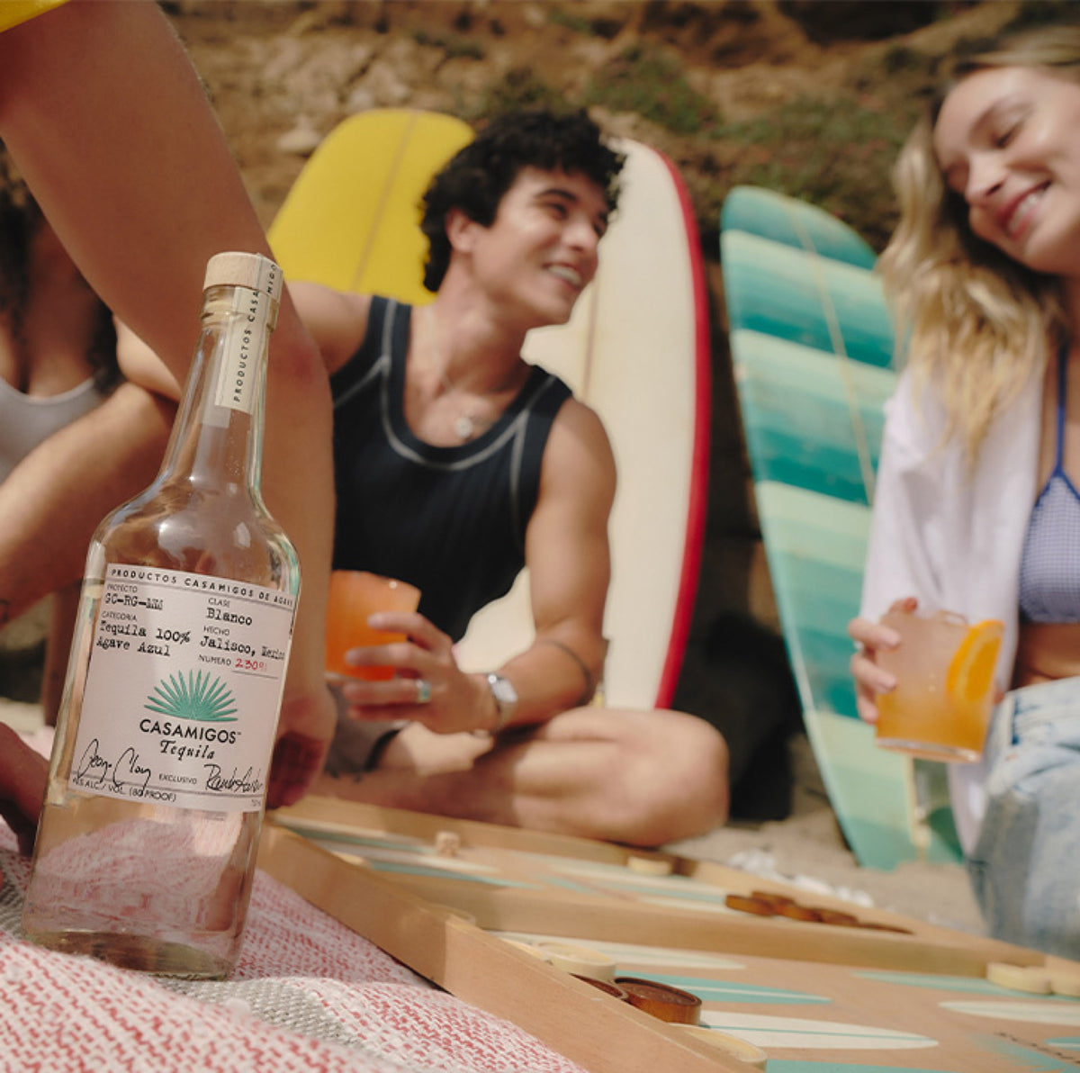 Friends sharing Casamigos tequila on the beach