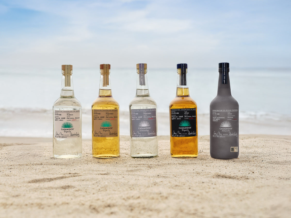 Casamigos tequila and mezcal bottles on the beach