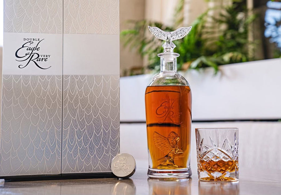 Double Eagle Very Rare bourbon decanter with a crystal eagle stopper, its box and a rocks glass